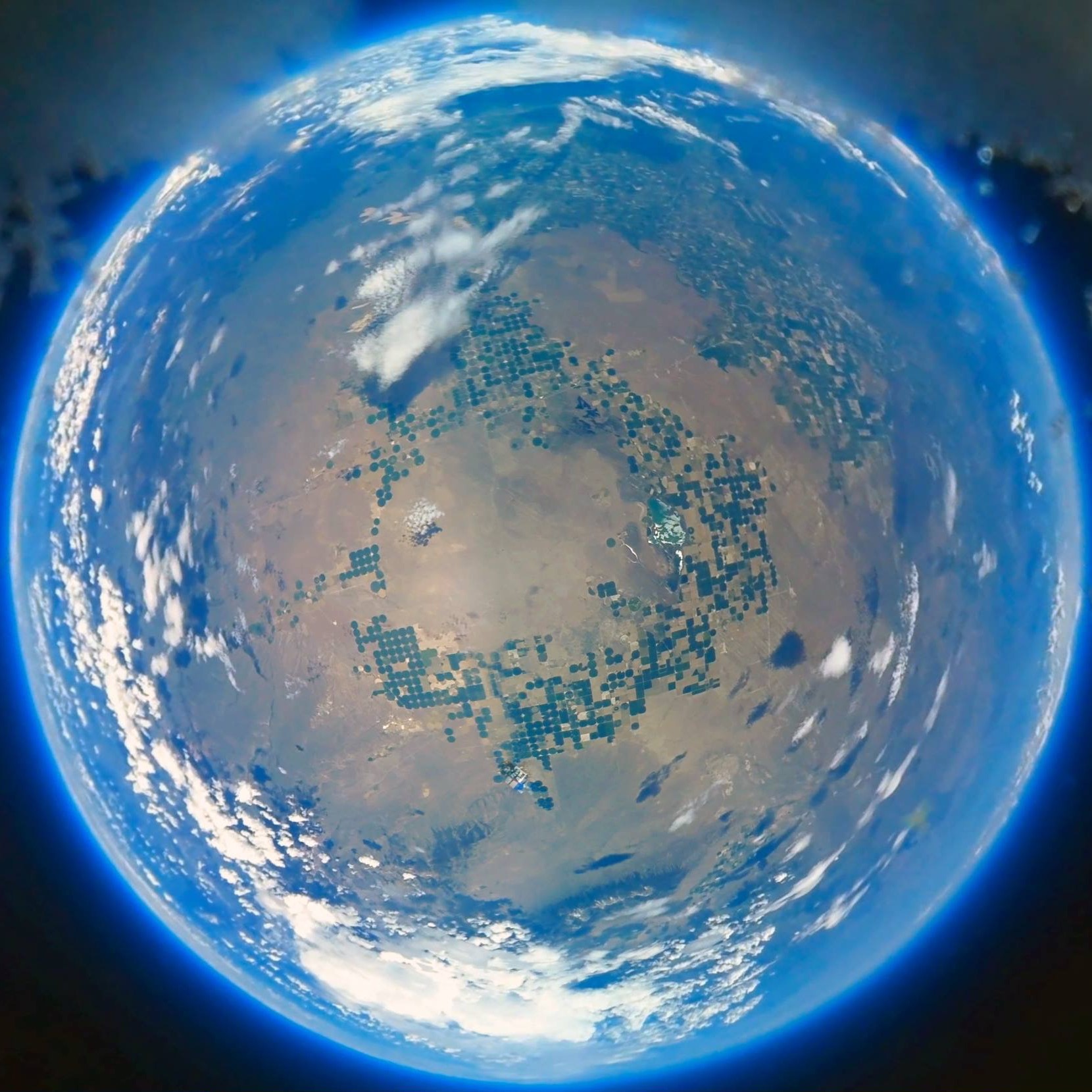 An image from a camera part of the payload of the balloon.
					The fisheye lense makes the ground appear like a sphere.